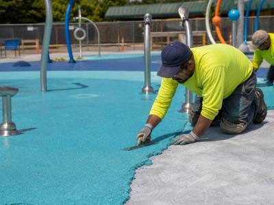 Splash pad being finished in blue rubber